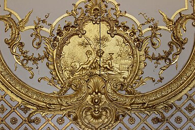 Rococo cartouche with putti in the Cabinet de la Pendule, Palace of Versailles, France, created and sculpted by Jacques Verberckt,1738[13]