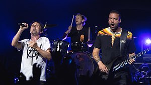 Matt Bellamy, Dominic Howard and Chris Wolstenholme on stage while performing