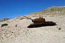 Russian/Soviet tank half-buried in sand on the beach on the island of Socotra in modern Republic of Yemen