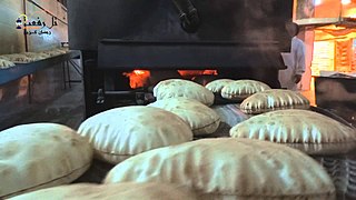 Baked khubz on conveyor in Tell Rifaat, Syria