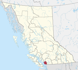 A map of British Columbia depicting its 29 regional districts and equivalent municipalities. One is highlighted in red.