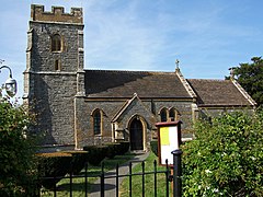 Stone building with square tower.