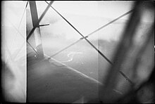 Black and white aerial photo of a ship taken from a long distance