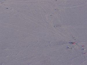 Sky Blu Melon hut and ancillary facilities, taken on approach to the runway. The hut and facilities are located about 1.5 kilometres (0.93 mi) from the runway, pictured top left.