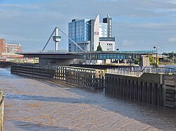 A metal bridge swung into an open position on the right hand side of the image. A river flows on the left side.