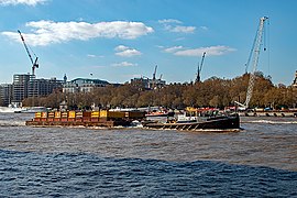 Resource tug towing barges of waste down the Thames