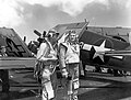 Two fighter pilots on board the USS Enterprise wait on deck during raid on Truk, Caroline Islands. February, 16, 1944