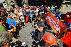 A young woman speaking to a crowd