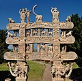 Carved decorations on the doorway of Sanchi stupa, note the dharma chakra, various animals, and Triratna (with srivasta in the center).