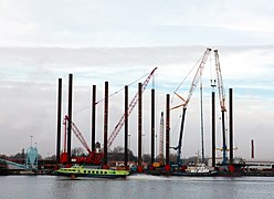 Jack-up barges, used to remove shipwrecks. In front appears to be a hydroplaning watercraft.