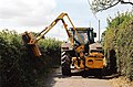 A reach flail mower used for cutting hedges