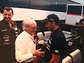 Bernie Ecclestone cumprimenta Nissany após a estreia oficial em finais de semana de GP da Fórmula 1, em 2005. Ao fundo, Paul Stoddart.