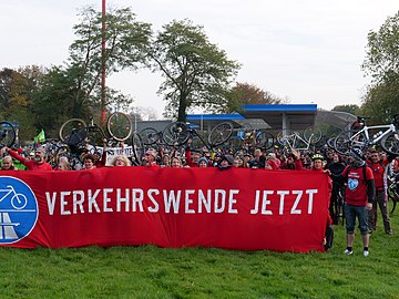 Cycling activists with bicycles and banner 'Verkehrswende Jetzt!' for a change in traffic behavior and emission free sustainable transport
