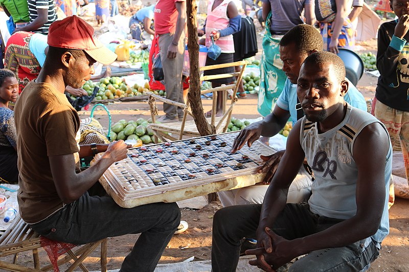 File:Playing a board game on the market in Chimoio.jpg