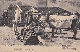 Carte postale en noir et blanc d'un homme et d'une femme, accompagnés d'un âne et d'une vache.