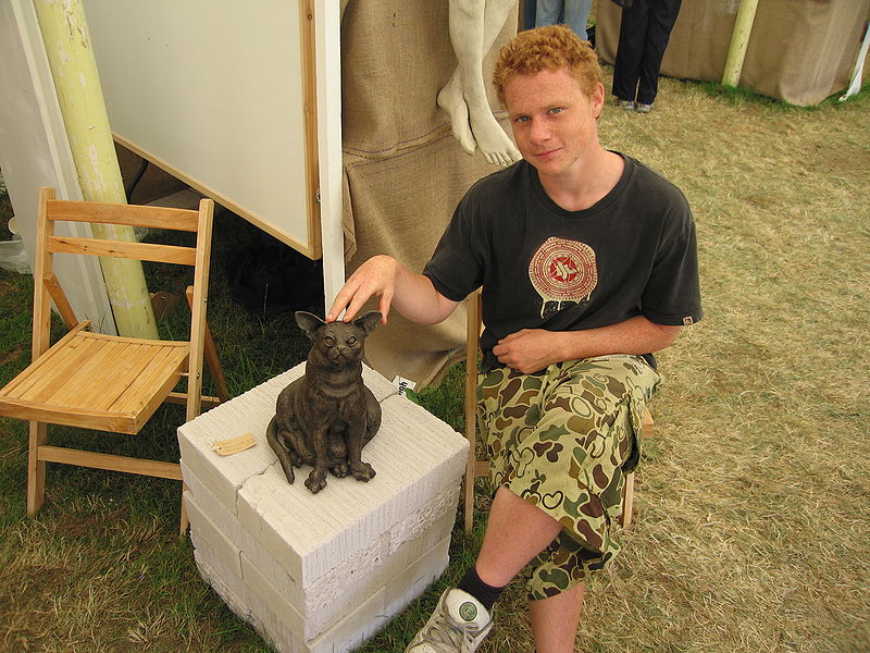 File:Person with bronze cat.jpg