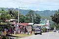 Jalan raya dengan deretan pertokoan di samping kiri