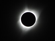 An image of a total solar eclipse at Orin Junction, Wyoming in 2017. A total solar eclipse happens when the Moon completely blocks the face of the Sun. It is the result of a cosmic coincidence. Even though the Sun is about 400 times bigger than the Moon, it is also about 400 times farther away. This makes the Sun and the Moon appear almost exactly the same size in our sky.