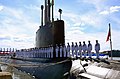 The crew of USS Minnesota mans the ship during her commissioning at Norfolk Naval Base on 7 September 2013.