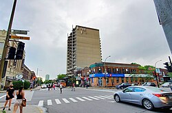 Pedestrians crossing the street diagonally in the summer