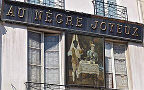 Au no 14, l'enseigne Au Nègre joyeux (déposée).