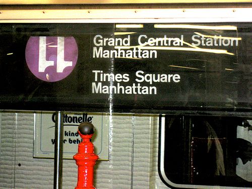 An R62A-class car operating on the 42nd Street Shuttle erroneously shows an upside down 11 sign instead of the usual, gray-backgrounded S for shuttles. The purple color currently corresponds to the IRT Flushing Line.