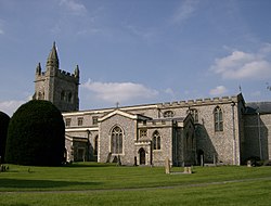 stone church with spire in a graveyard