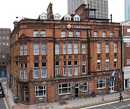 Former Market Hotel (to the left of the Old Rep). Built in sandstone in 1883 by Thomson Plevins. At the back of the hotel the original workshop of the Old Rep can just be seen.