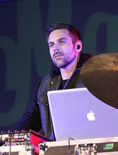 Shot of a man standing beyond his turntables.