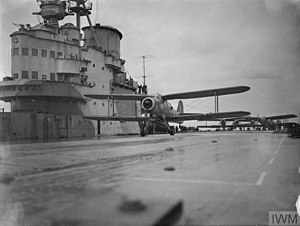 Black and white photograph of biplanes on a metal surface