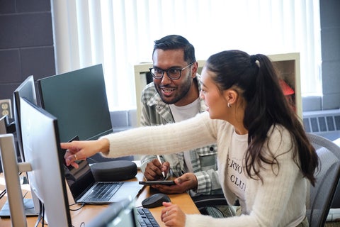 Students looking at a computer monitor