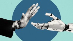 A human hand turning down a handshake from a robot hand