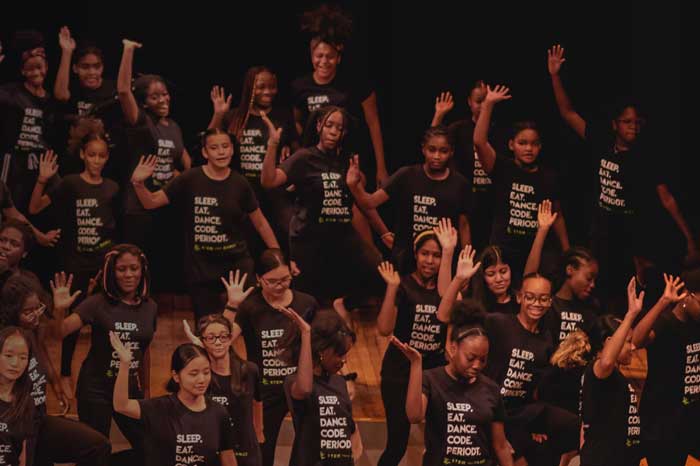 A large group of dancers with the same STEM shirts