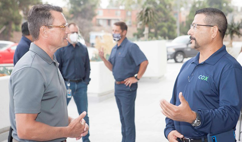 two men outside talking