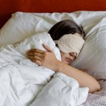 Article thumbnail: a woman sleeping with a Eye Sleeping Mask on her head