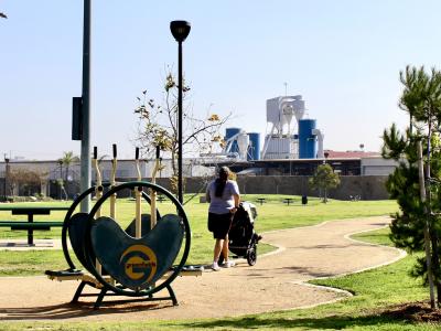 parent pushing a stroller on track at park in South Los Angeles