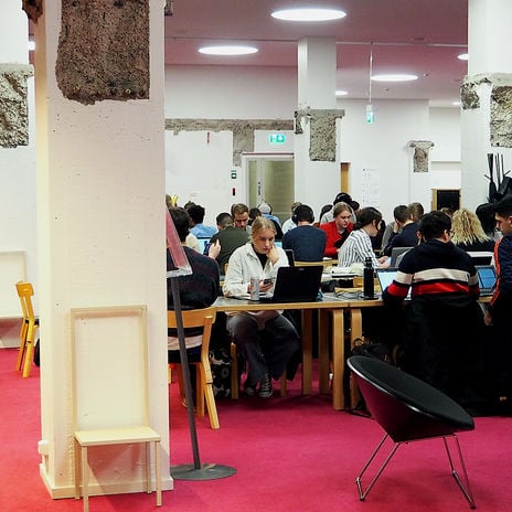 Photo from the K-floor of the Harald Herlin Learning Centre, students working at desks.