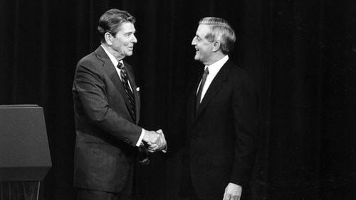 FILE - President Ronald Reagan, left, and his Democratic challenger Walter Mondale, shake hands before debating in Kansas City, Mo., Oct. 22, 1984. (AP Photo/Ron Edmonds, File)