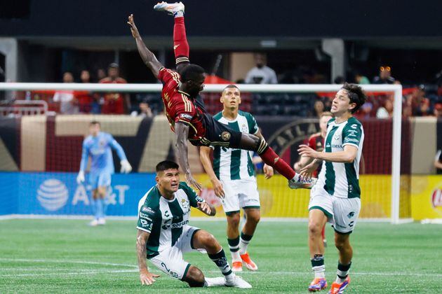 Atlanta United forward Jamal Thiare, top center left, is fouled by Santos Laguna defender Bruno Agustin Amione (2), bottom center left, during the second half of a Leagues Cup match soccer match Sunday, Aug. 4, 2024, in Atlanta. (Miguel Martinez/Atlanta Journal-Constitution via AP)