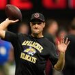 Atlanta Falcons quarterback Kirk Cousins warms up, while wearing an Apalachee High School T-shirt following a recent school shooting there, before an NFL football game against the Pittsburgh Steelers on Sunday, Sept. 8, 2024, in Atlanta. (AP Photo/John Bazemore)