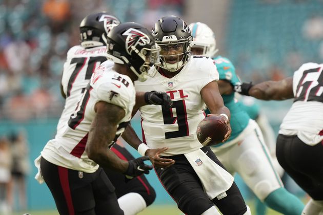 Atlanta Falcons quarterback Michael Penix Jr. (9) hands the ball to running back Jase McClellan (30) during the first half of a pre season NFL football game against the Miami Dolphins, Friday, Aug. 9, 2024, in Miami Gardens, Fla. (AP Photo/Wilfredo Lee)