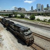 A Norfolk Southern train travels south close to the Mitchell Street bridge in downtown Atlanta's Gulch in May 2013. (Jason Getz/AJC)