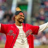 Grammy winning artist, Usher, throws out the ceremonial first pitch of a baseball game between the Los Angeles Dodgers and the Atlanta Braves, Saturday, Sept. 14, 2024, in Atlanta. The Braves won the game 10-1.  (AP Photo/Jason Allen)