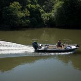 Chattahoochee Riverkeeper Executive Director Jason Ulseth scours the river for irregularities during a boat patrol ride with the organization on June 12. (Riley Bunch/AJC 2024)