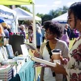 Candice Nicole (left) and Shaliss Monet (right) browse through books during the 2022 Decatur Book Festival. After a one-year hiatus, the festival returns Oct. 4-5. (Christina Matacotta for The Atlanta Journal-Constitution)