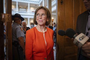 Dr. Janice Johnston, a member of the State Election Board, enters after a brief recess during a meeting at the Capitol in Atlanta, Tuesday, Aug. 6, 2024. (Matthew Pearson/WABE via AP)