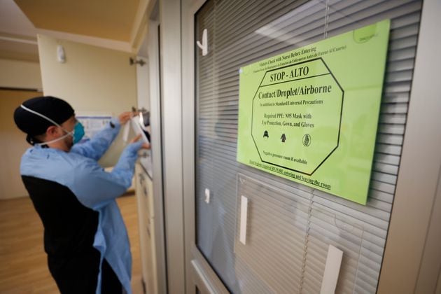 COVID-19 still poses a threat, especially to those who are medically vulnerable, including older adults. A sign advises medical personnel and visitors to take precautions before entering rooms with patients infected with COVID-19 at the Northeast Medical Georgia Center in Gainesville last February. (Miguel Martinez/The Atlanta Journal-Constitution/TNS)