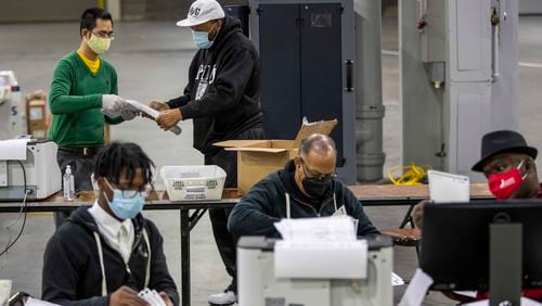 Fulton County elections workers sort and count absentee ballots during the county's second recount of presidential Election Day ballots at the Georgia World Congress Center in November 2020. It was the third tally of votes in a race decided by a narrow margin, with Joe Biden defeating President Donald Trump by about 12,000 votes out of some 5 million ballots cast in Georgia. (Alyssa Pointer / Alyssa.Pointer@ajc.com)