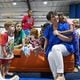 Tabitha Hatfield, 45, smiles while receiving a hug from one of her students, 6-year-old Rylee Pearson, at Elite Heat, Sandersville's athletic training facility. Education is a top issue for Hatfield, who is critical of school vouchers and wants to keep public schools strong. “I’m going to look for someone who is going to invest in the future of our children,” she said. (Hyosub Shin / AJC)