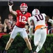 Georgia quarterback Brock Vandagriff (12) attempts a pass against Tennessee-Martin defensive lineman Devonte Murray (10) during the fourth quarter at Sanford Stadium, Saturday, Sept. 2, 2023, in Athens, Ga. Georgia won 48-7. (Jason Getz / Jason.Getz@ajc.com)